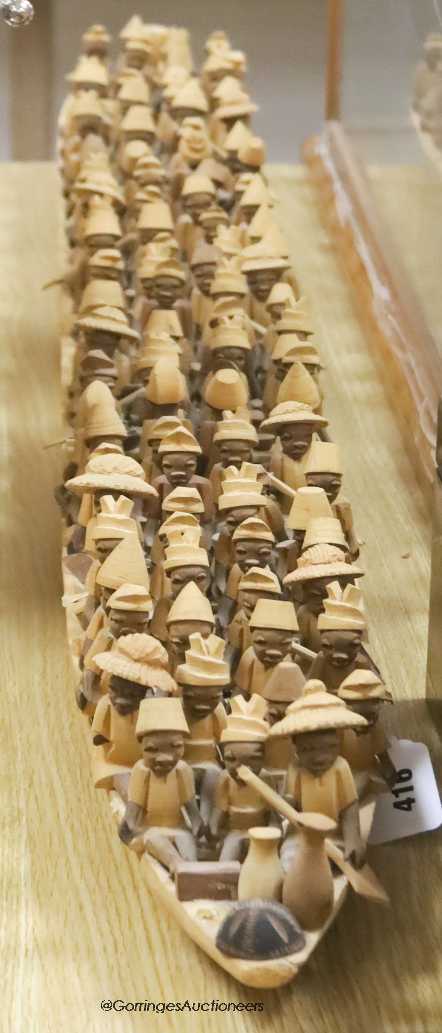 An African wood model of figures in a boat, length 155cm